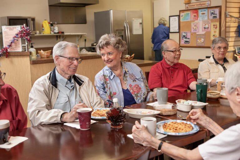 group of seniors sitting around table and discussing myths around aging
